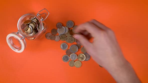 Putting Coins In Money Box