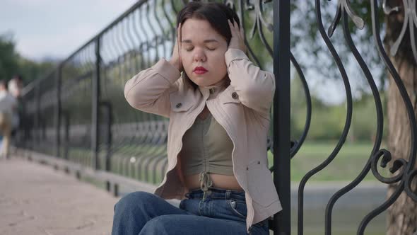 Nervous Stressed Little Person with Dwarfism Having Migraine Holding Head in Hands Closing Eyes alt