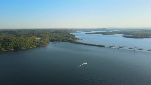 Aerial Birds Following View of a Hige River Bay and the Green Rainforest Under the Setting Sun
