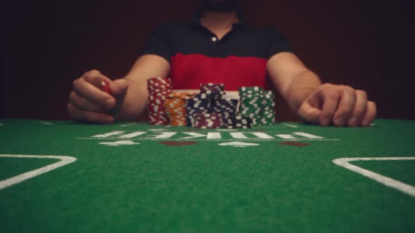 Male Player Betting All Chips in While Playing in Casino Close Up