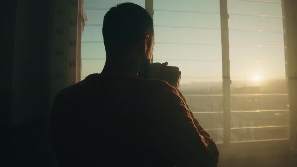 Boy with cup at the window alt