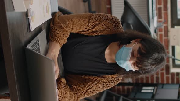 Business Employee Typing Charts Information on Laptop alt