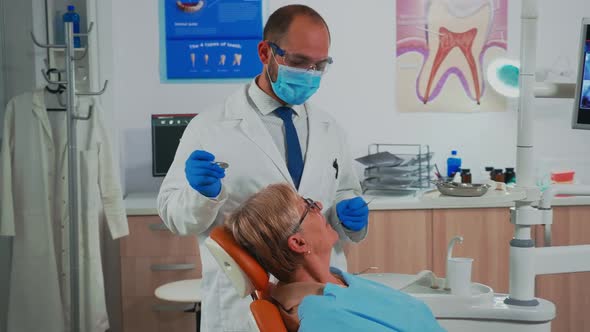 Orthodontist Examinating Patient Using Sterile Dental Tools alt
