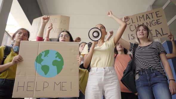 Multiethnic Group of Teen on a Protest March Carrying Signs with Environmental and Conservation alt