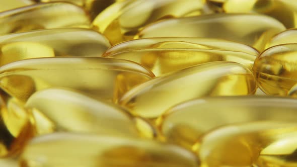 Super Macro View Omega 3 Gold Fish Oil Capsules Rotation Background