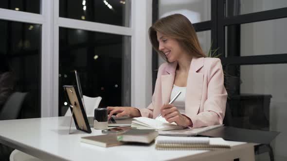 Female Boss is Working in Office Black Woman is Making Notes in Notebook Sitting at Table with