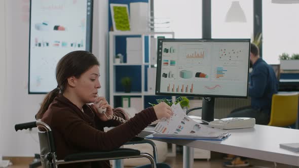 Financial Woman Expert Sitting Immobilized in Wheelchair Speaking at Phone alt