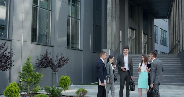 Businessman in Suit Talking to Business People Colleagues or Partner alt