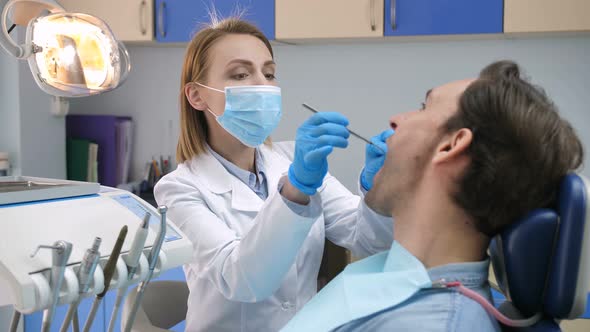 Portrait of Female Dentist Examining Patient alt