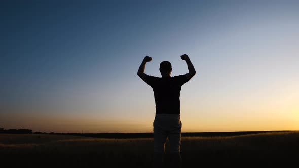 Strong powerful man flexing his arms up to the sky. Mental and physical strength concept.