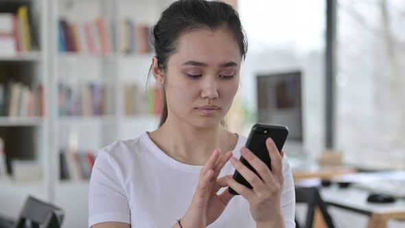 Portrait of Young Asian Woman Having Loss on Smartphone  alt