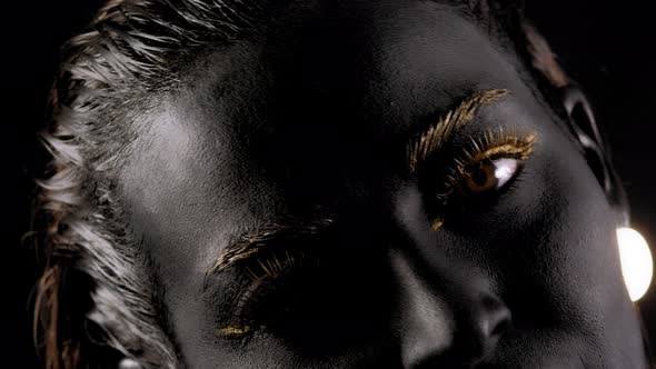 Portrait of a Young Woman with Magical Black Skin and Golden Hands alt