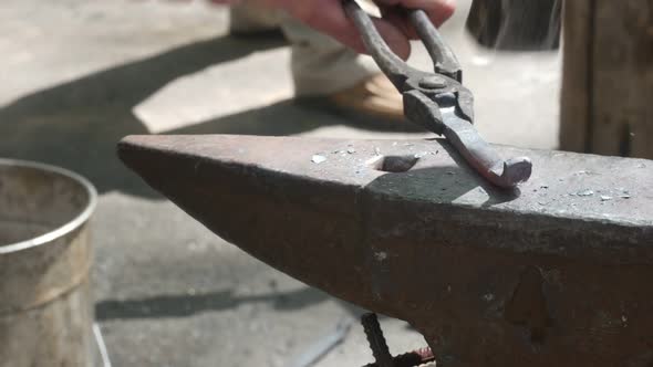 Modern Blacksmith Forges Hot Metal With A Hammer alt