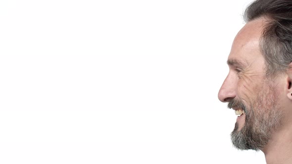Slowmotion Closeup Profile Shot of Happy Charming Granfather Confident Male with Beard Start Smiling alt