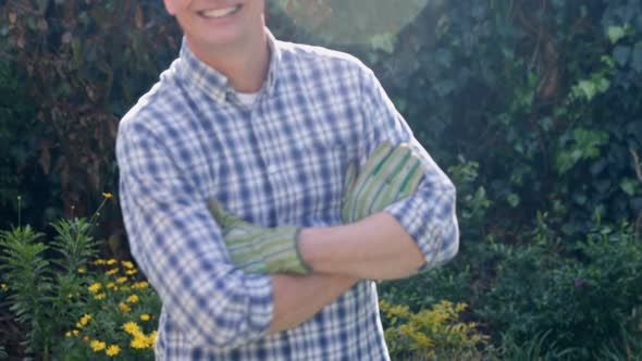 Man standing with arms crossed in the garden 4k alt