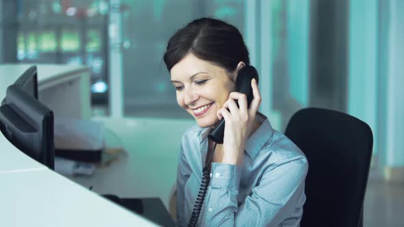 Office receptionist transferring phone call