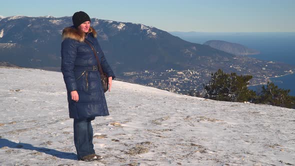A Woman Standing On a Snow-Covered Plateau
