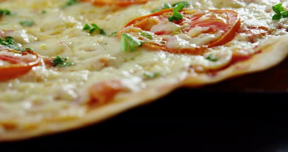 Baked pizza with cherry tomato toppings alt