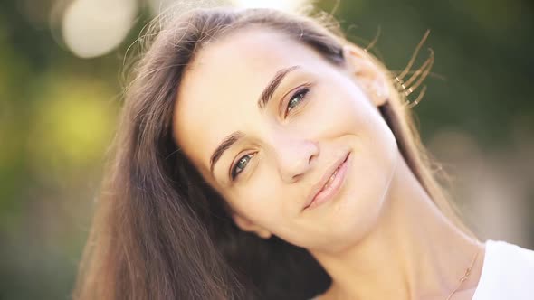 Portrait of Beautiful Caucasian Woman Smiles and Enjoys of the Moment Isolated on Blur Background