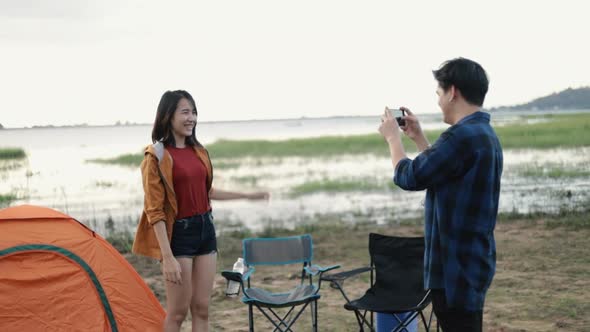 Young couple campers trekking in mountains park taking selfie on a sunny beautiful landscape nature.