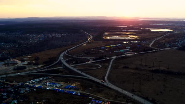 Huge road junction full of cars and trucks in countryside in winter, aerial view alt
