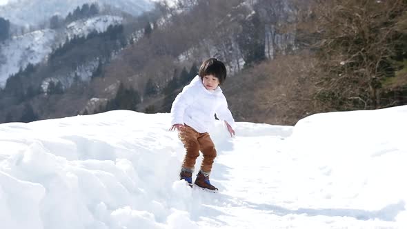 Cute Asian Child Playing Snow Outdoors Slow Motion alt
