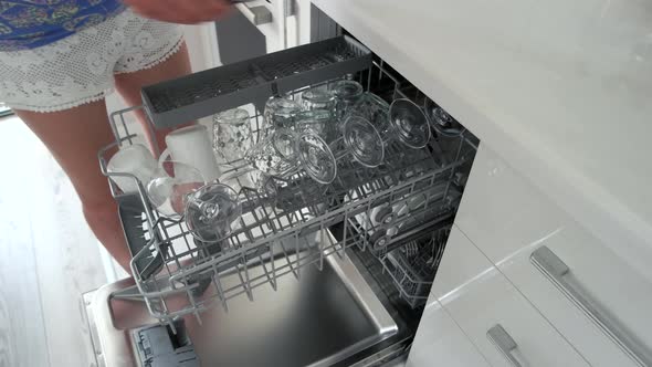 Woman Taking Out Glasses and Cups From Dishwasher alt