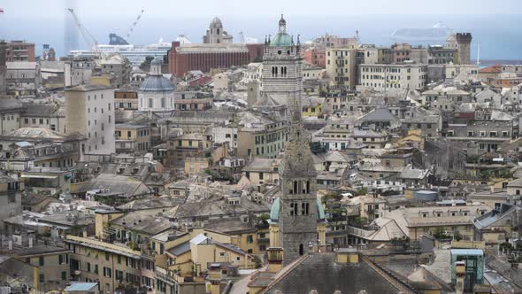 Beautiful cityscape of Genoa city with towers and rooftops, tilting up view alt