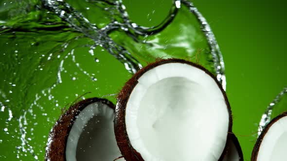 Super Slow Motion Shot of Flying Fresh Coconuts and Water Side Splash at 1000Fps. alt