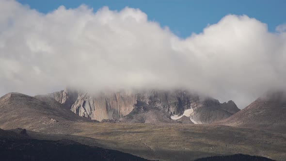 Time lapse of fast moving clouds in front of mountain range alt