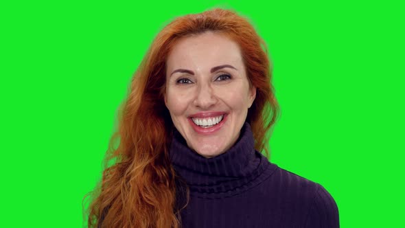 Portrait of Pretty Female Face Smiling and Laughing on Green Screen Background