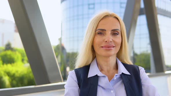 Portrait of Businesswoman Standing Outside a Modern Corporate Building alt