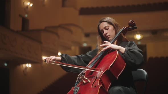 Emotional Woman is Playing Violoncello in Music Hall Female ...