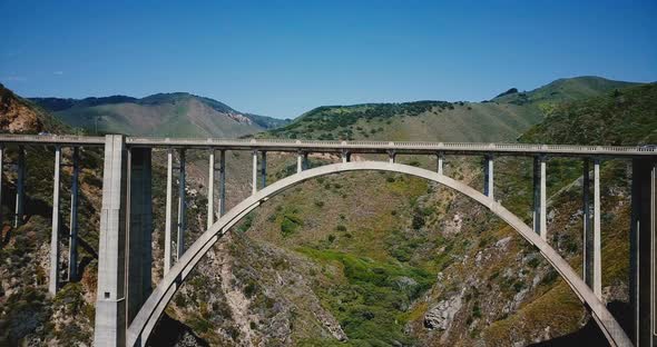Drone Is Flying Right Under Iconic Famous Bixby Creek Bridge at Highway 1, Famous American Travel alt