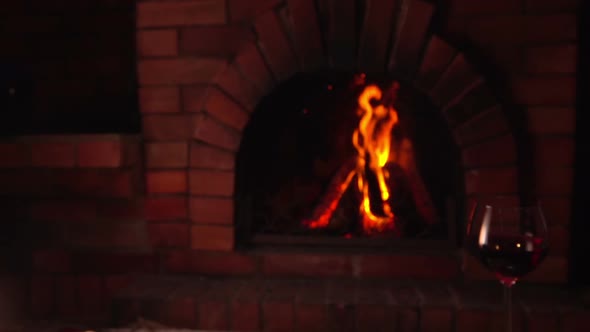 Plate with Baked Chicken Is Placed on the Glass Table on the Background of Fire alt