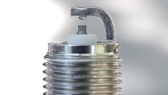 Macro View of a New Spark Plug. Rotation alt