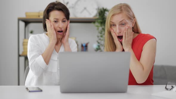 Two Surprised Women with Laptop