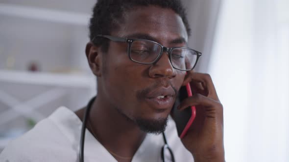 Closeup Positive Confident Doctor in Eyeglasses Talking on Phone Smiling alt