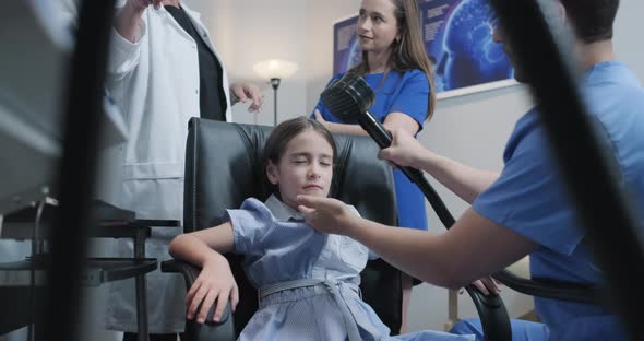 Autistic Little Girl Undergoing Transcranial magnetic stimulation in Hospital Laboratory
