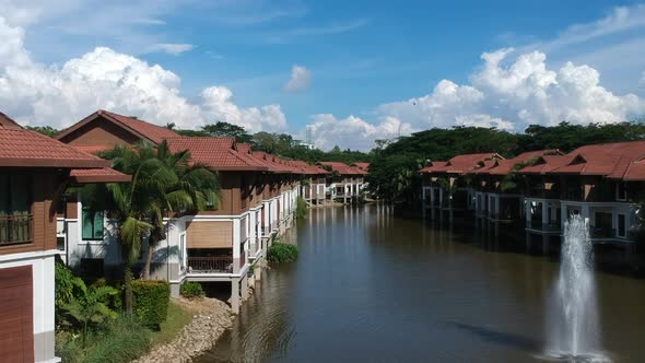 wide shots of homes by the lake with bird flying and blue sky in the background alt