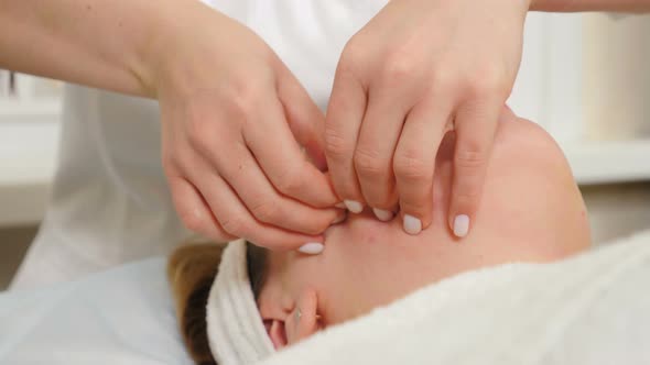Facial Massage Performed By Professional Beautician in Beauty Clinic alt