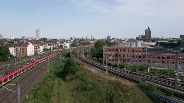 Two commuter S-Bahn trains meet in the north of cologne just before the central station in a midday alt