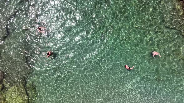 People swim in the azure sea aerial view 4 K alt