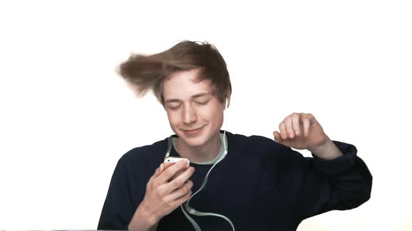Portrait of Hipster Boy in Braces Listening His Favourire Music on Smartphone with Headphones alt