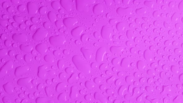 Rotating Bright Purple Background with Water Drops Top View