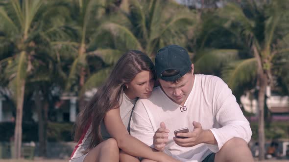 Lady with Long Loose Hair Waved By Light Wind Hugs Guy alt