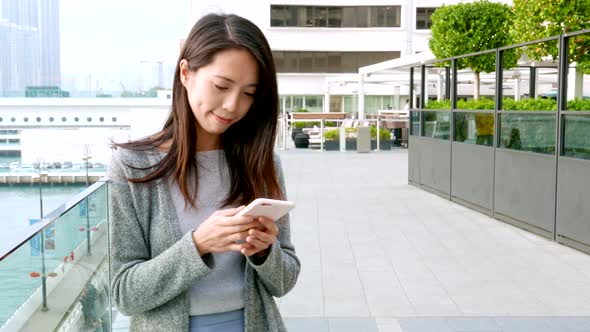 Woman use of cellphone at outdoor alt