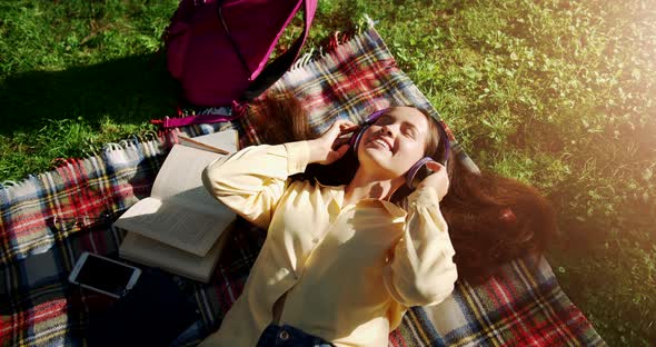 Female Student Listening Music Top View