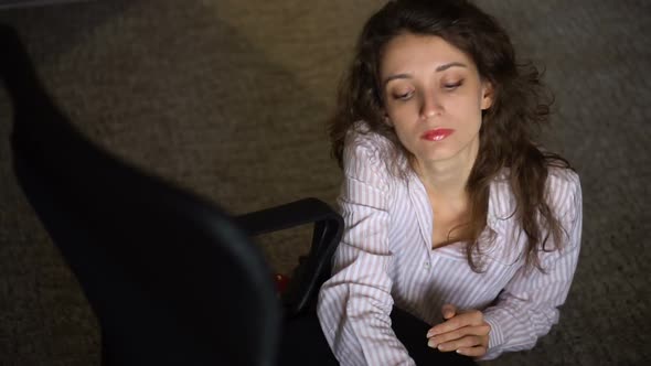 Young Businesswoman with Red Lipstick and Red High Heels is Climbing on a Chair From the Floor alt