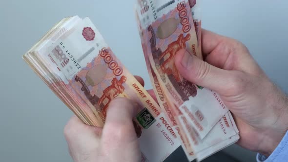 Closeup of Hands Counting Fivethousandth Banknotes of the Russian Ruble